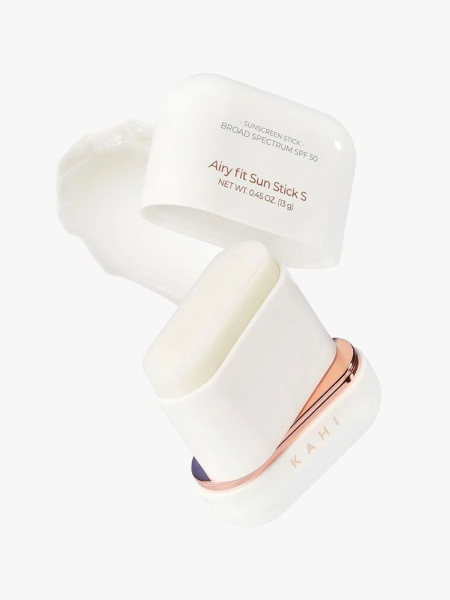 Kahi Airy Fit Sun Stick SPF Broad Spectrum 50+ white sunscreen stick with lid ajar on light gray background